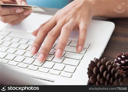 Online payments, Woman holding credit card and using laptop computer, Online shopping concept
