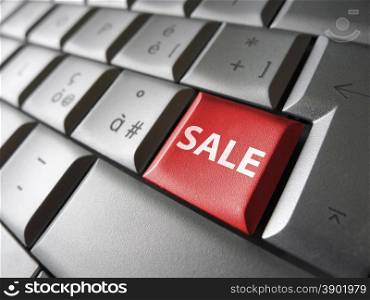 Online sales web and Internet concept with sale sign and word on a red laptop computer key for blog, website and online business.