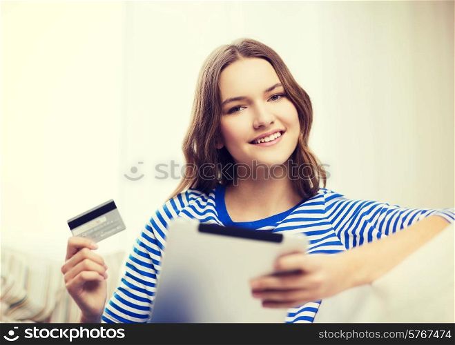 online shopping and technology concept - smiling teenage girl with tablet pc computer and credit card