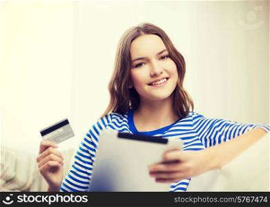 online shopping and technology concept - smiling teenage girl with tablet pc computer and credit card