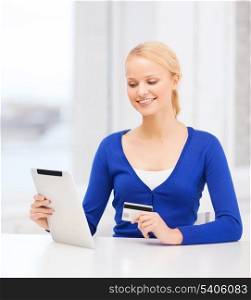 online shopping and technology concept - smiling young woman with tablet pc computer and credit card