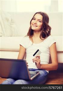 online shopping, banking and technology concept - smiling teenage girl with laptop computer and credit card at home