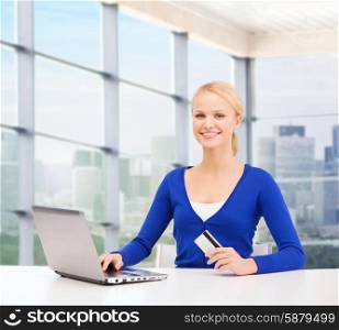 online shopping, banking, business and people concept - happy businesswoman with laptop and credit card over office window background