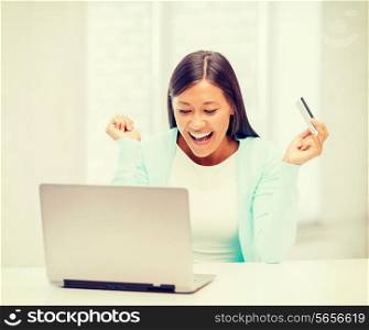 online shopping, banking, business, happy people concept - smiling woman with laptop and credit card