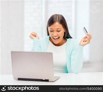 online shopping, banking, business, office, happy people concept - smiling businesswoman with laptop and credit card