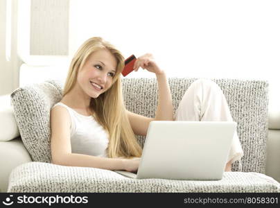 Online Shopping - Beautiful Blonde Sitting on th Sofa with Cradit Card