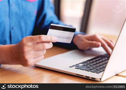 Online shopping credit card data security concept, Hands holding credit card and using smart phone or laptop to shopping or making online payment
