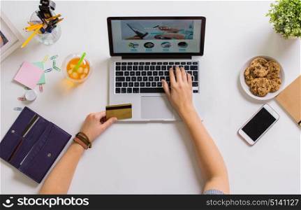 online shopping, finances and technology concept - hands with laptop computer and credit card at table. hands with laptop and credit card at table