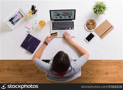 online shopping, finances and technology concept - woman with laptop computer and credit card at table. woman with laptop and credit card at table