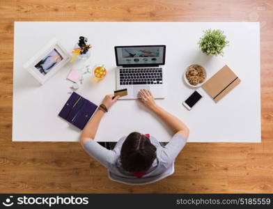 online shopping, finances and technology concept - woman with laptop computer and credit card at table. woman with laptop and credit card at table