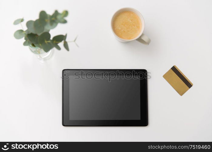 online shopping, sale and technology concept - tablet pc computer, credit card and cup of coffee on white background. tablet pc computer, credit card and cup of coffee