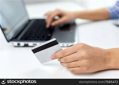 online shopping, technology and people concept - teenage girl with laptop computer and credit card at home. teenage girl with laptop and credit card at home