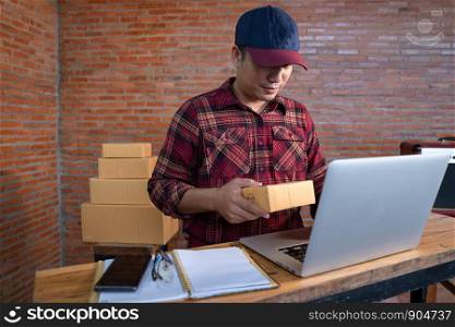 Online shopping young start small business in a cardboard box at work. The seller are preparing products to deliver to their customers, online sales.