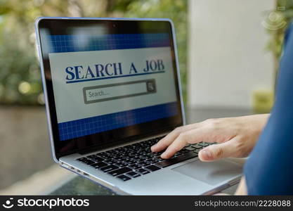 Online studying concept the pale hand of a man trying to type on laptop keyboard for searching the definition of a few words that he cannot understand.