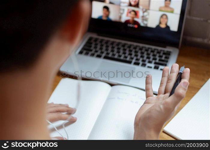 Online studying concept the university student trying to explain his opinion towards the subject that he concludes on the notebook while his classmates are listening to it.
