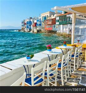 Open-air cafe near famous houses by the sea in Mykonos Island, Greece
