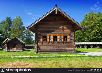 Open-air museum of ancient wooden architecture. Russia. Vitoslavlitsy, Great Novgorod.Church and well