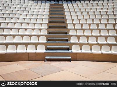 Open air theater with natural daylight; plastic seat rows