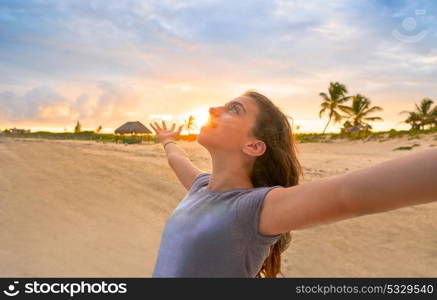 Open arms girl at sunset caribbean beach in Mexico