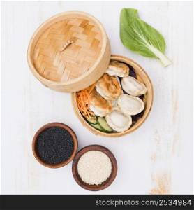 open bamboo steamers with dumplings sesame seeds textured backdrop