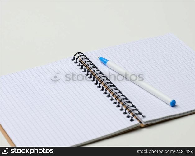 open blank notebook with pen on white table