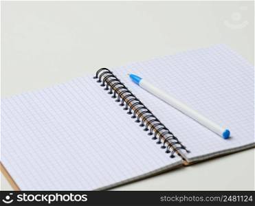 open blank notebook with pen on white table