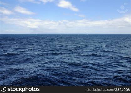 Open blue sea deep water and sky horizon background.