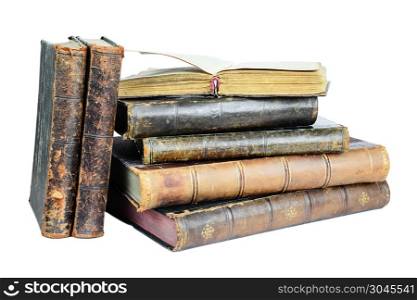 Open book lies on a pile of old books isolated on a white background. Old books isolated on a white