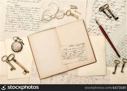 Open book, old letters, antique accessories. Nostalgic vintage style background