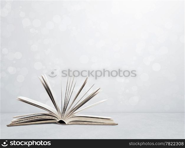 Open book on wall background