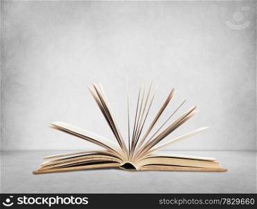 Open book on wall background