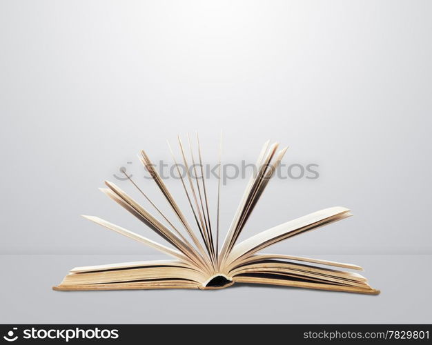 Open book on wall background