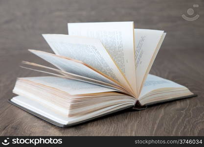 Open book on wood background