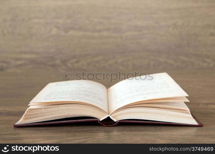 Open book on wood background