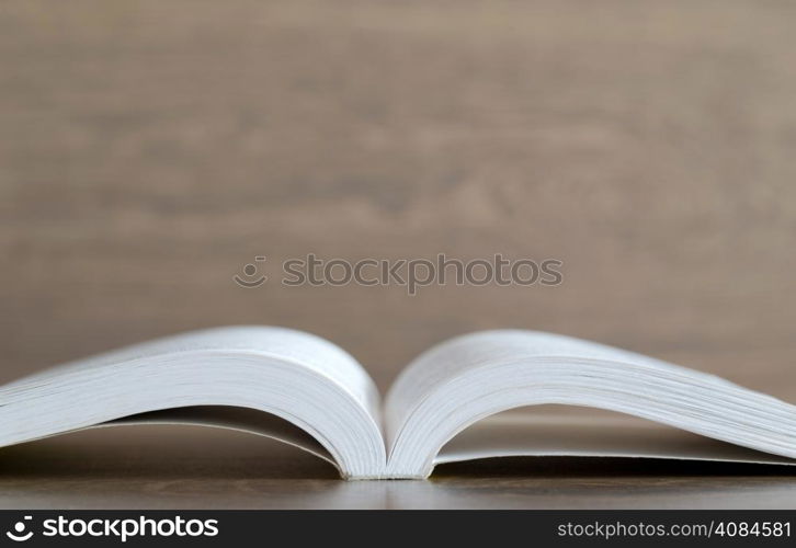 Open book on wood background