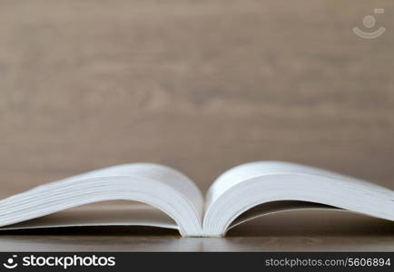 Open book on wood background