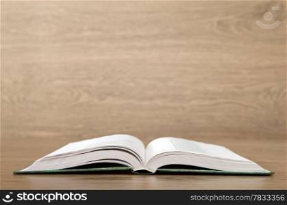 Open book on wood background