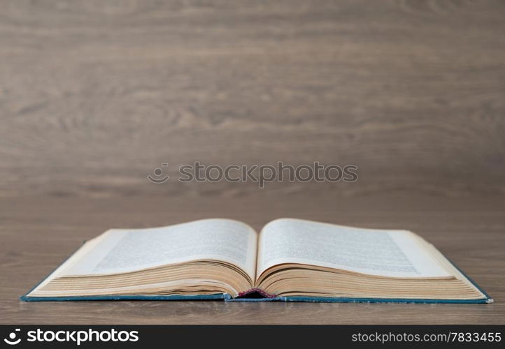 Open book on wood background