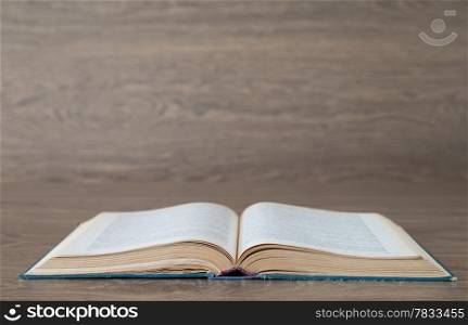 Open book on wood background