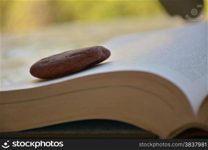 open book with a stone paperweight