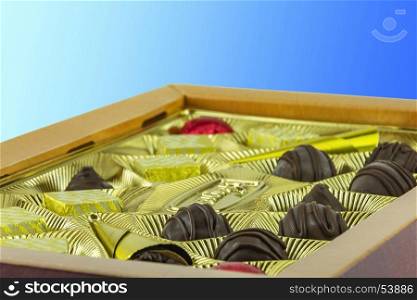 Open box of chocolates on a blue background