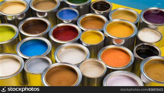 Open cans of paint, blue background