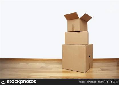 Open cardboard box on the floor in empty room, ready for transport