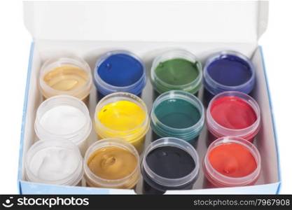 Open colorful cans of gouache paint in box isolated