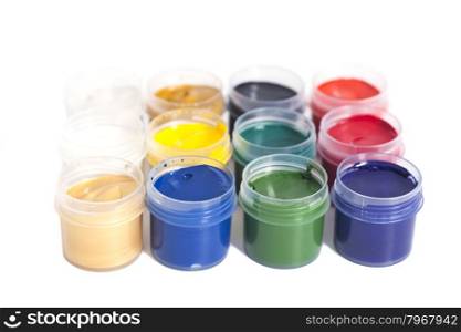 Open colorful cans of gouache paint isolated on white