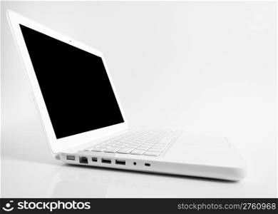 Open computer laptop with reflection of white table