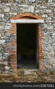 Open doorway leading into old stone building in Tuscany, Italy.