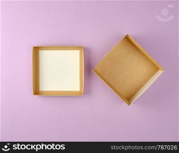 open empty brown craft box on a purple background, top view