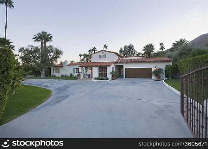 Open gate and driveway of Palm Springs home