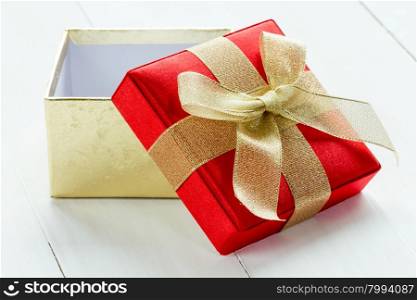 Open gift box on the white wooden background
